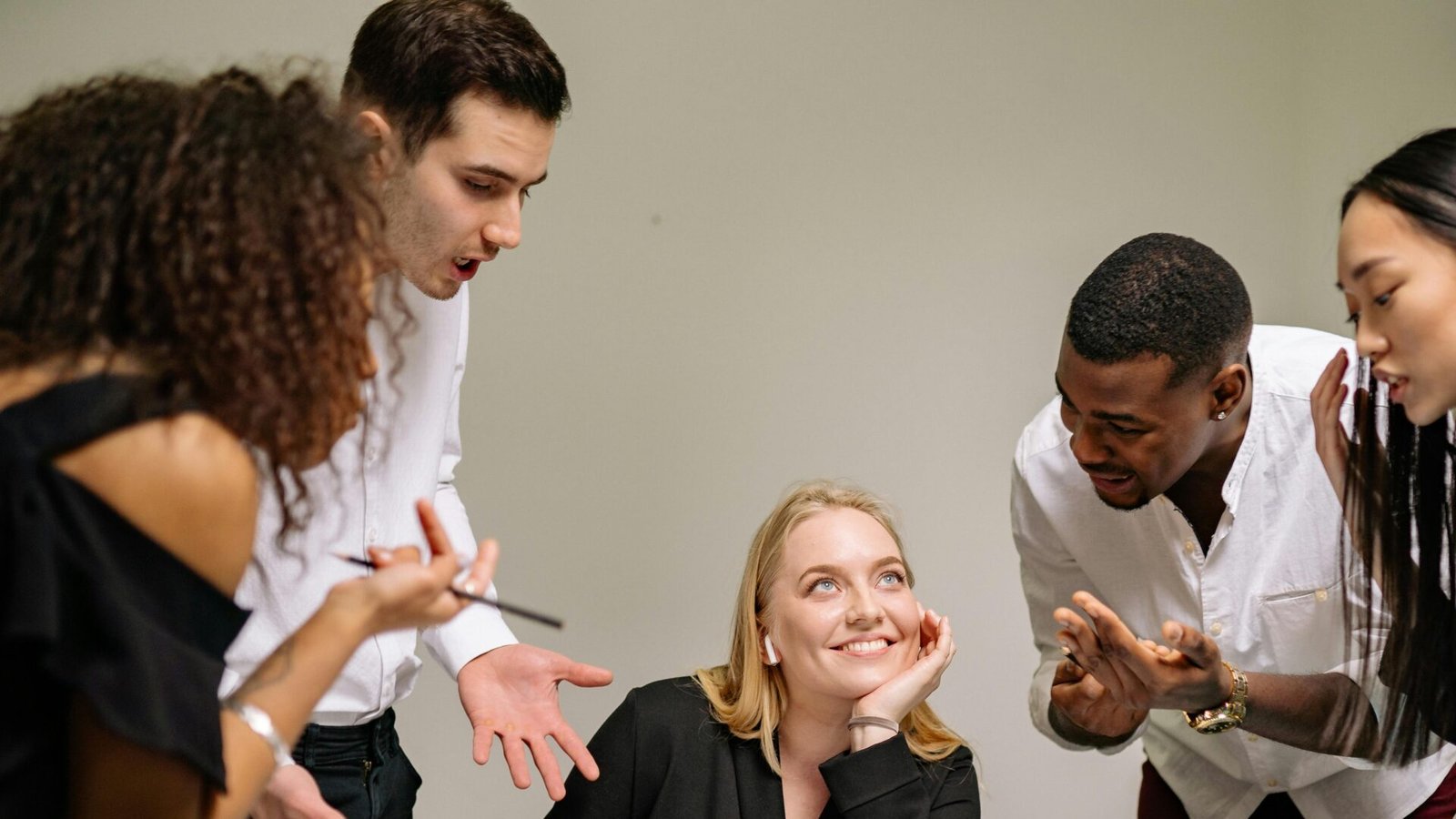 A diverse group of professionals engaged in an animated discussion at the workplace.